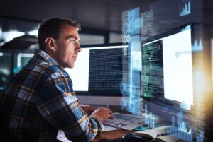 Man working on computer with tech graphic overlay