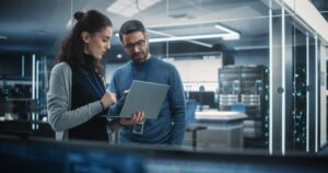 Portrait Of Two Female And Male Engineers Using Laptop Computer